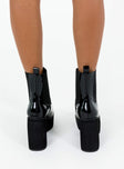 Black platform boots Faux patent leather Ankle boot style Square toe Elastic gusset detailing Pull tab at back