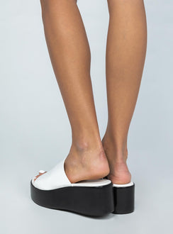 Platform heels Wide base Single thick upper Rounded toe Vegan leather