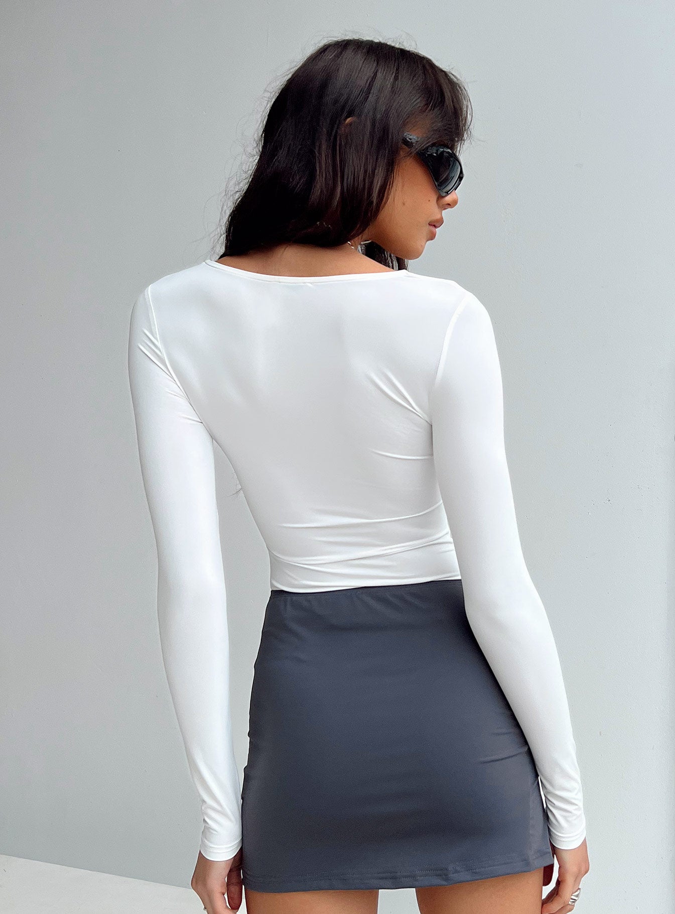 back view of model wearing Princess Polly Tadmor Bodysuit Ivory Sleeveless V-Neck 