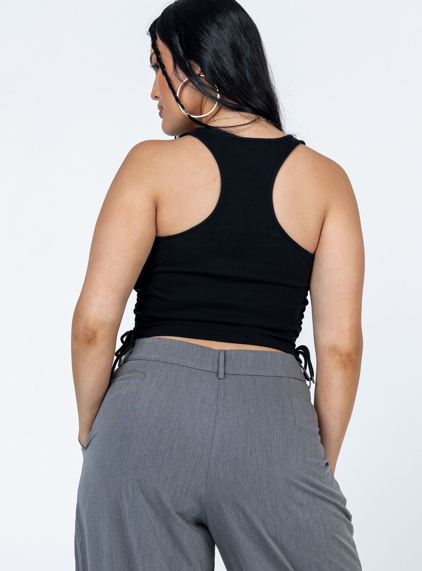 back view of model wearing Princess Polly Walker Top Black Sleeveless Scoop Neck 