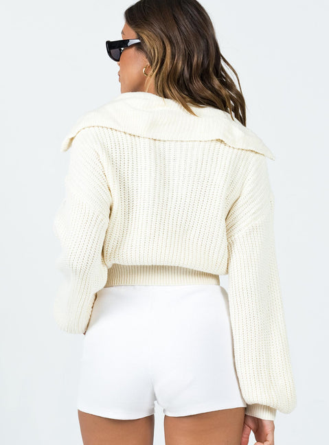 Sweater 100% polyester  Knit material  Turtle neck  Zip front fastening  Drop shoulder  Cropped design 