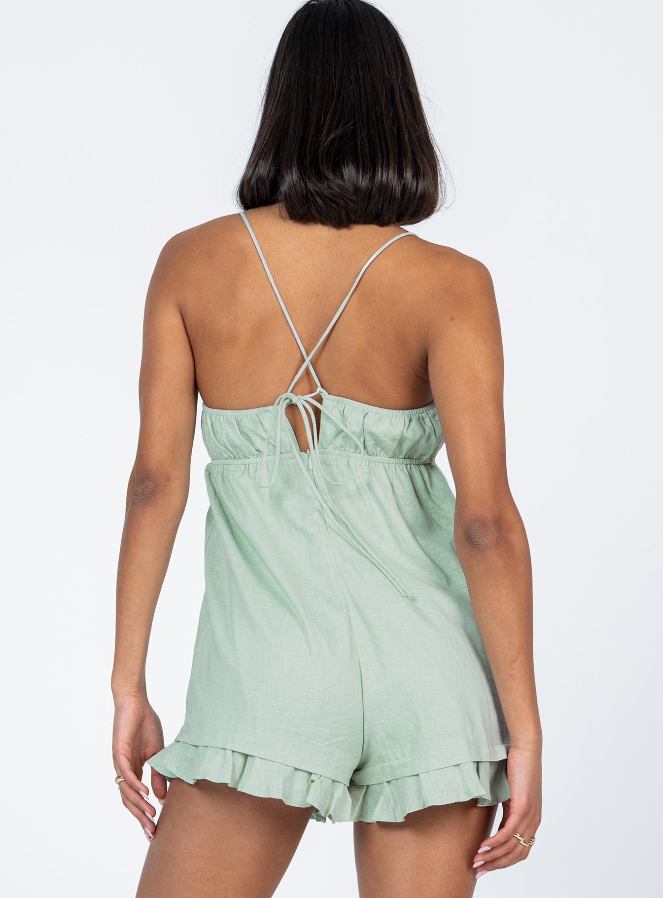 Romper Elasticated neckline & waistband  Tie fastening at bust  Tie back straps  Invisible zip fastening  Frill hem 