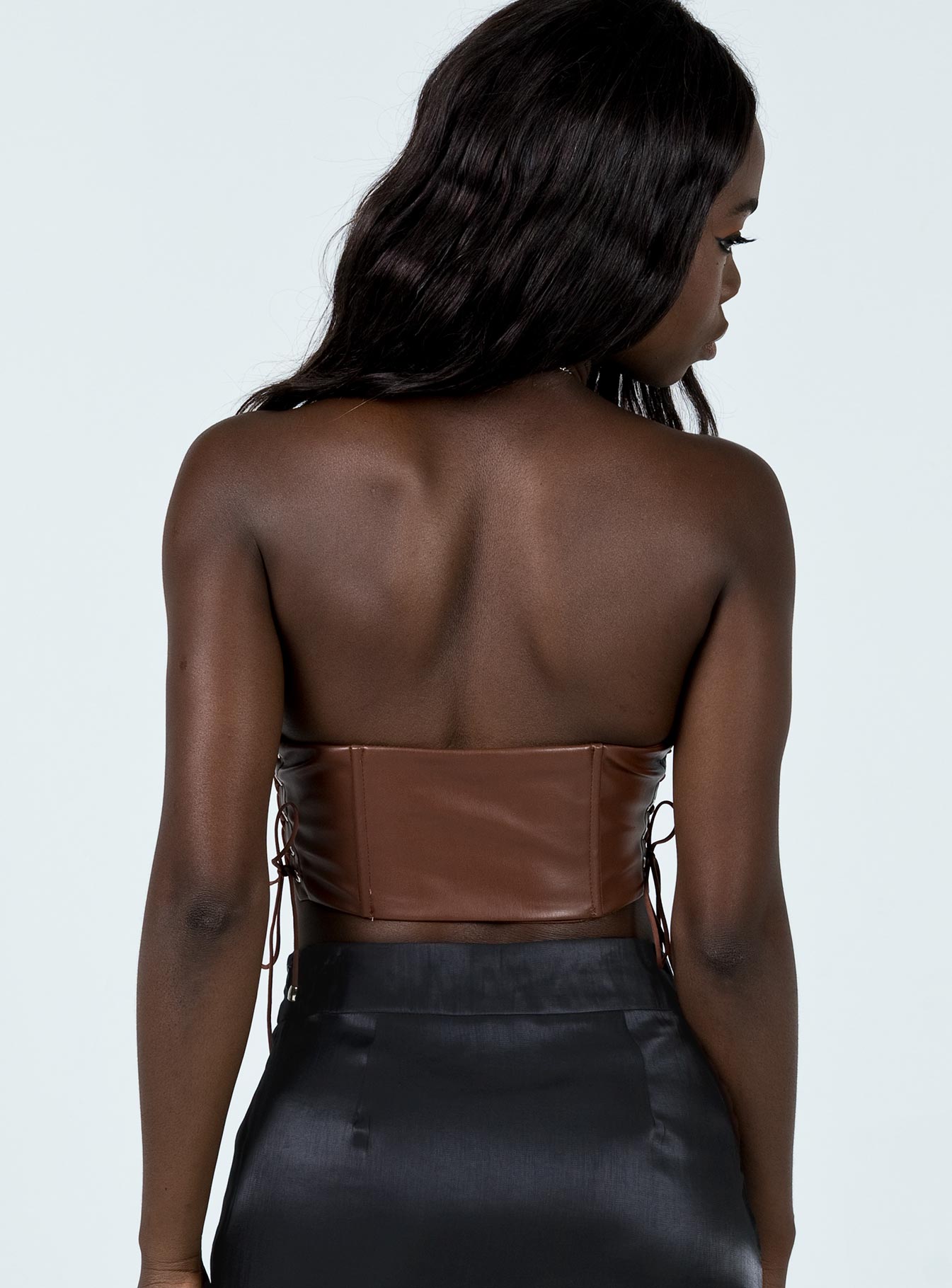back view of model wearing Princess Polly Maddox PU Strapless Top Brown 