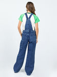 Overalls Dark wash denim  Embroidered graphic at chest  Adjustable shoulder straps Chest & leg pockets Four classic pockets  Button fastening at hips Wide leg 