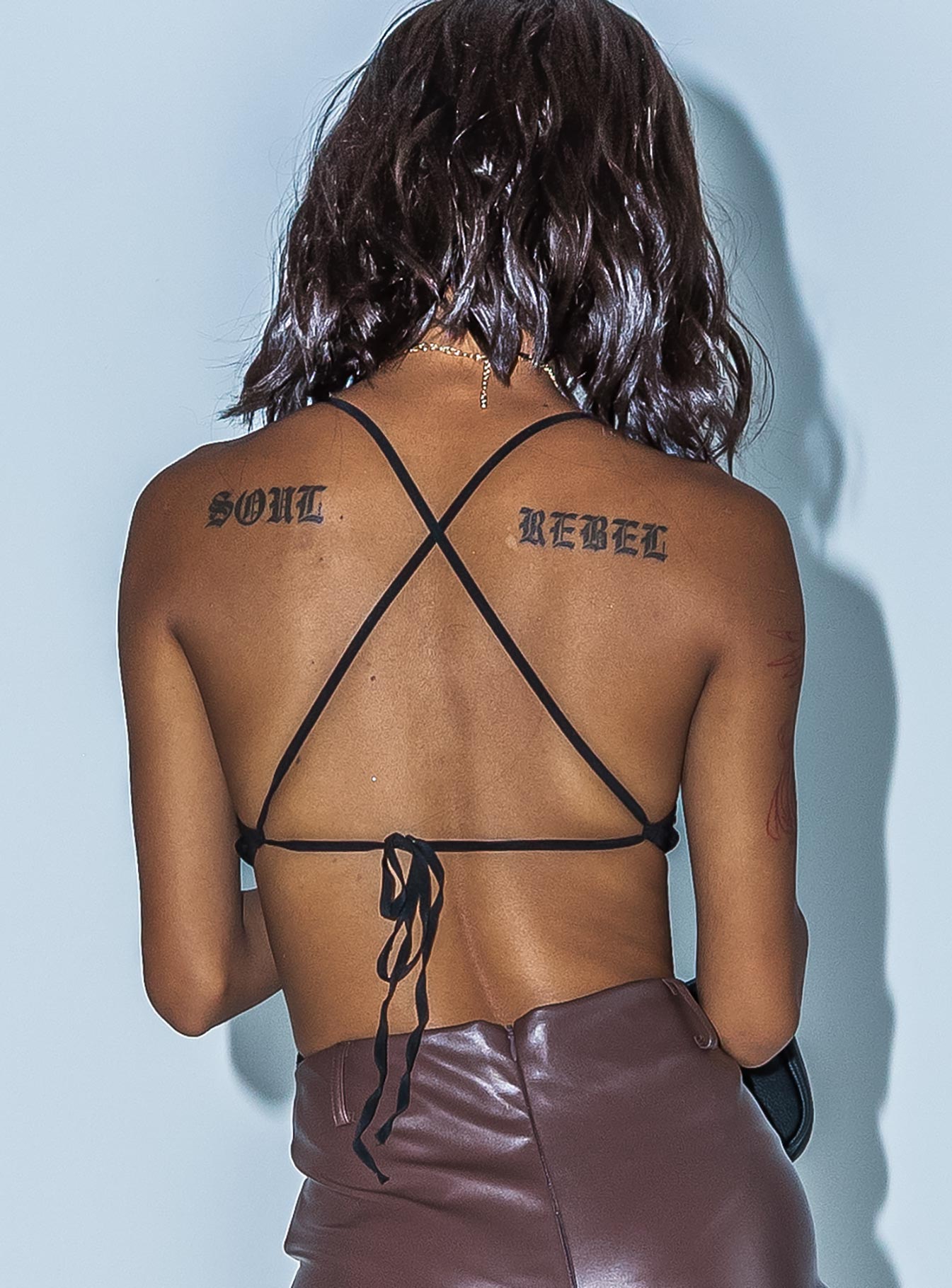 back view of model wearing Princess Polly Henrietta Bodysuit Black Sleeveless Plunger 