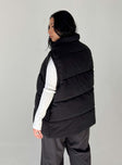 Puffer vest High neck Quilted stitching Zip front fastening  Twin hip pockets Adjustable toggles at hem