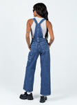 Overalls Mid wash denim  Embroidered graphic at chest  Adjustable shoulder straps Chest & leg pockets Four classic pockets  Button fastening at hips Wide leg 