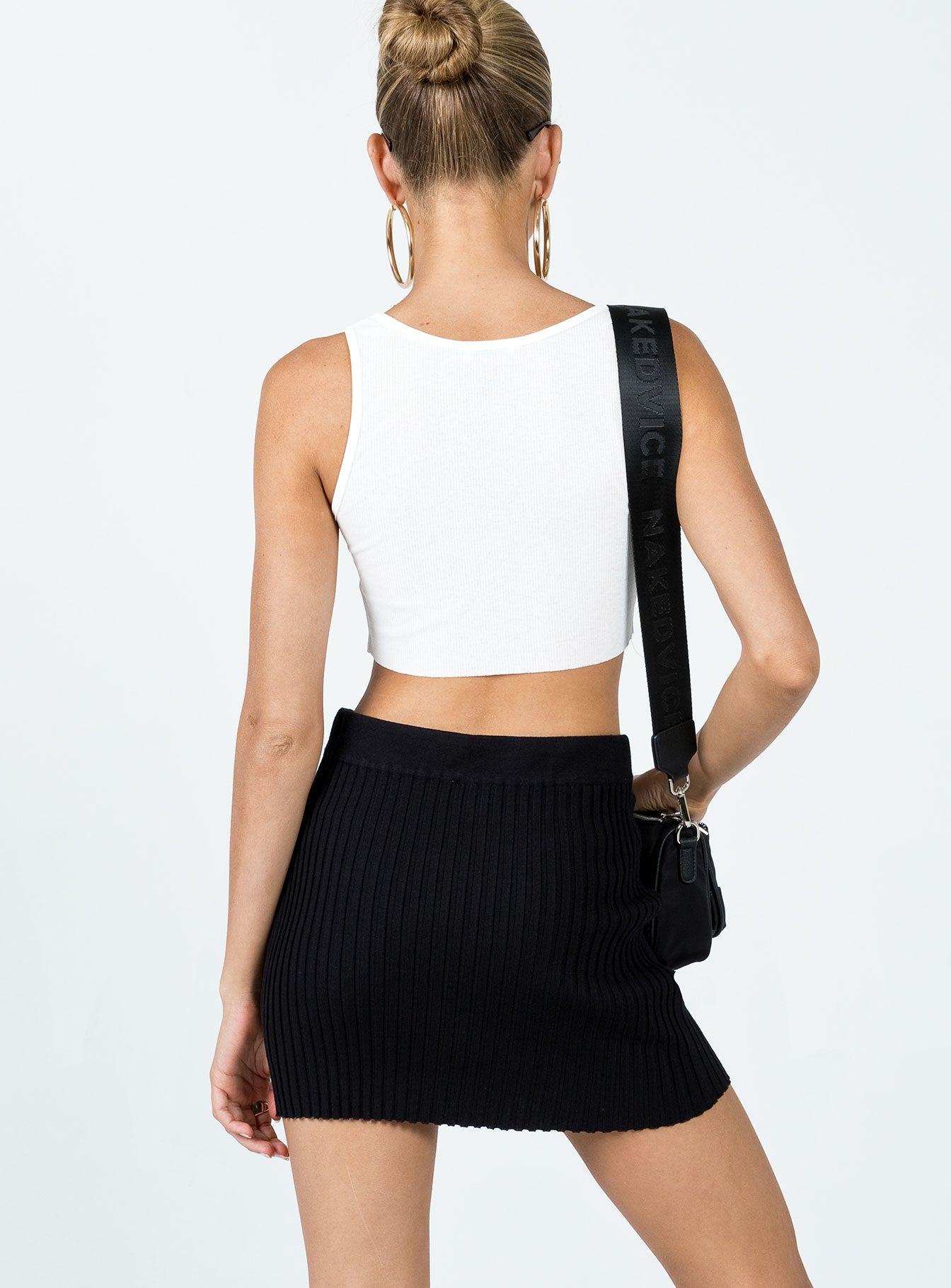 back view of model wearing Princess Polly Nina Rib Knit Mini Skirt Black 