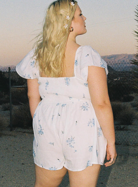 Romper 100% cotton Floral print  Elasticated shoulders & neckline  Tie at bust  Shirred waist 