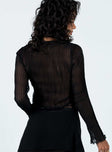 Long sleeve top Sheer plisse material V-neckline Single tie fastening at bust Lace trim detail Flared cuff