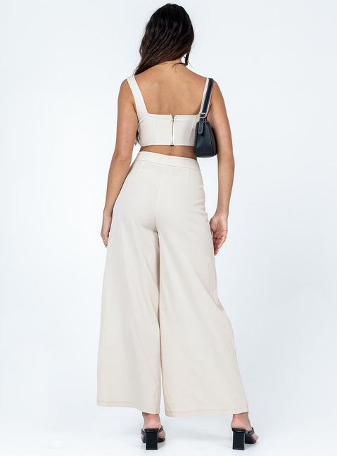 Matching set Silky material  Corset top  Boning through front  Zip fastening at back  High waisted pants  Invisible zip fastening at side  Wide leg 