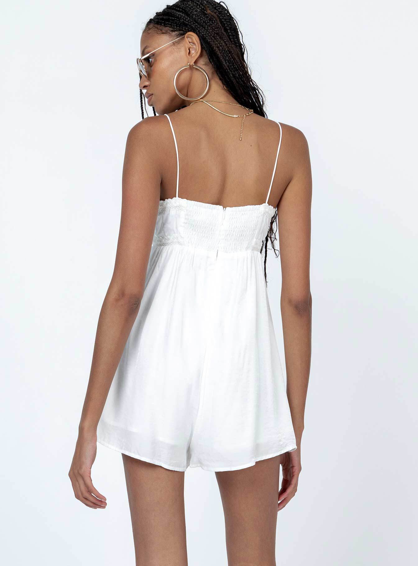 Romper Silky material  Lace trimming  Elasticated shoulders Tie at bust  Shirred back  Invisible zip fastening at back 