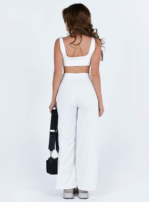 White matching set Crop top Fixed straps Invisible zip fasting at side High waisted pants Wide relaxed leg Belt loops at waist Zip and button fastening Stuble pleats at waist Twin hip pockets Non stretch  Lined top