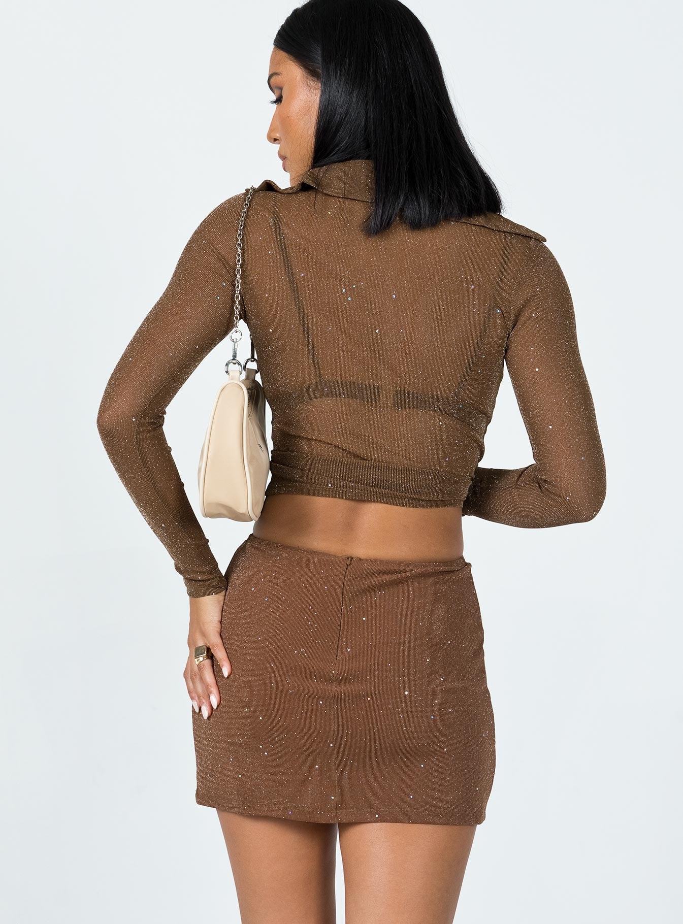 back view of model wearing Princess Polly Selby Mini Skirt Brown Glitter 