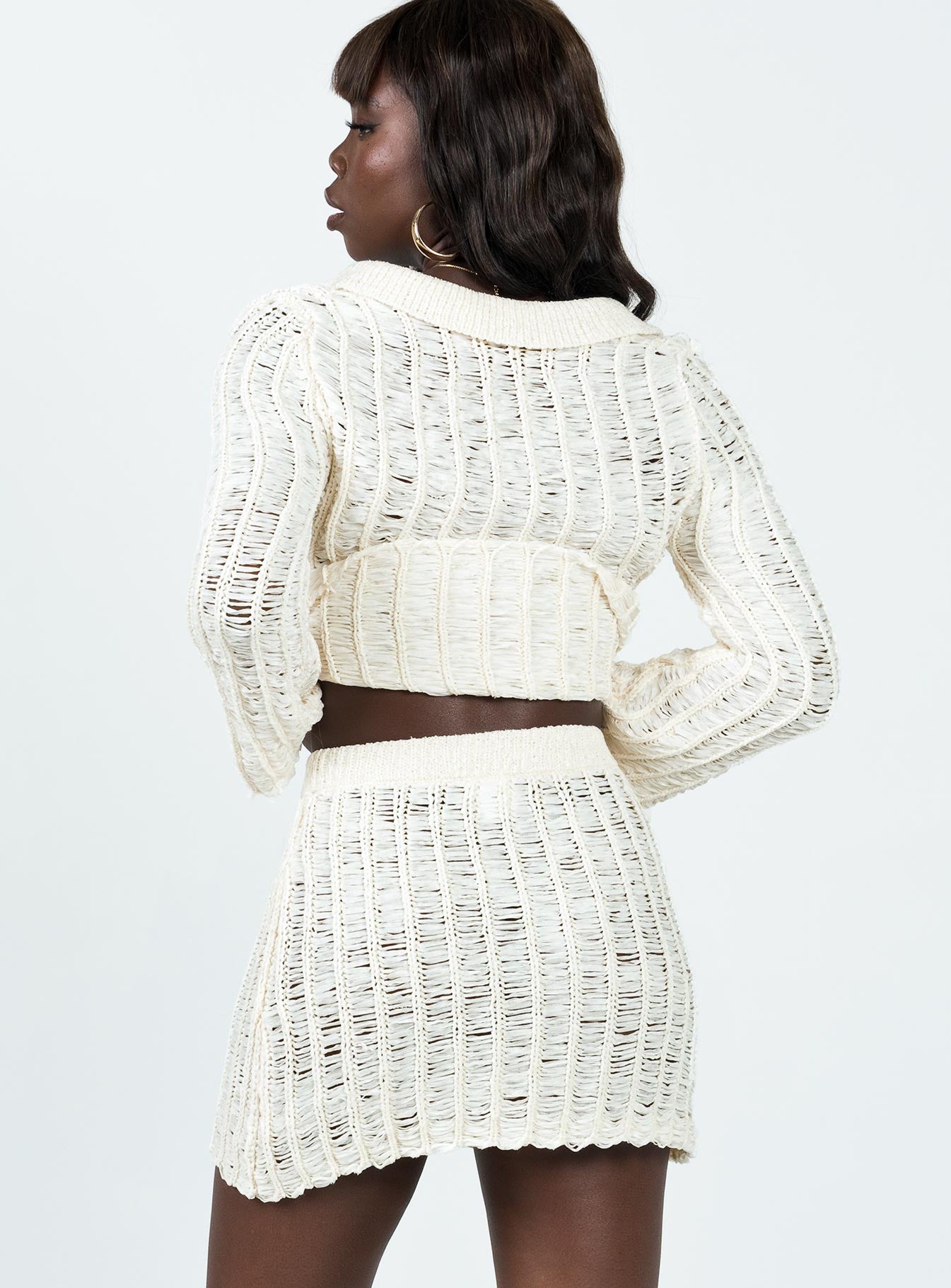 Matching set Knit material Long sleeve top V-neckline Classic collar Button fastening at front Mini skirt Elasticated band at waist Good stretch