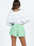 back view of model wearing Princess Polly Beach House Shorts Green Stripe High Waisted Shorts 