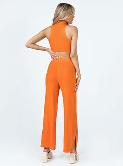 Matching set Ribbed material Tank top Mock neck Low cut sides High waisted pants Elasticated waistband Wide leg Slits at cuff