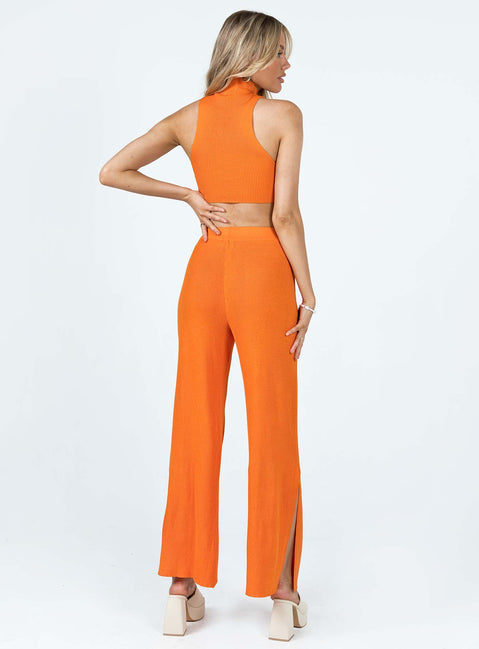 Matching set Ribbed material Tank top Mock neck Low cut sides High waisted pants Elasticated waistband Wide leg Slits at cuff