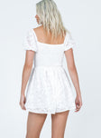 White romper Textured material  Elasticated puff sleeves  Shirred waist  Fixed tie at bust 