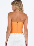 Orange strapless top Inner silicone strip at bust Boning through waist Zip fastening at back Good stretch Fully lined 