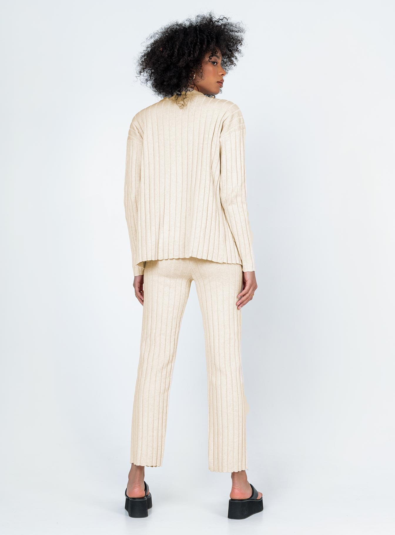 Matching set  Relaxed fit Princess Polly Exclusive 63% recycled polyester 25% polyester 12% nylon Heavy wide ribbed material  Long sleeve button up top   Twin front pockets  High waisted pants  Elasticated waistband Slim leg  Raw-edge hem 