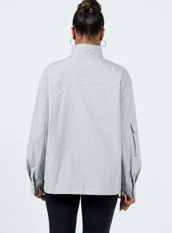 Jacket Windbreaker material High neck Zip front fastening Cargo style pocket on right sleeve Twin front pockets Press studs at cuff Drawstring hem