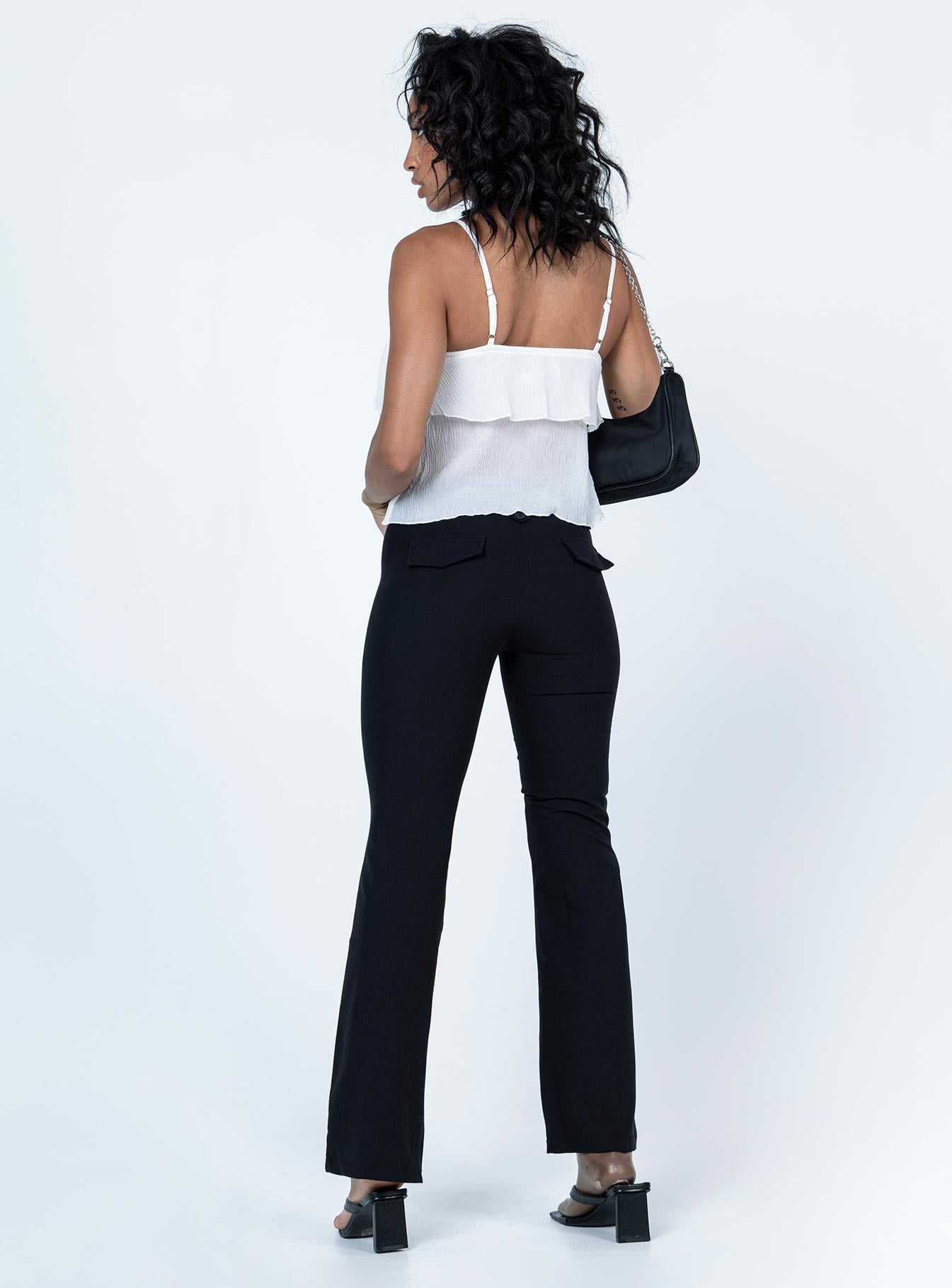 back view of model wearing Princess Polly Yianna Low Waist Flare Pant Black 