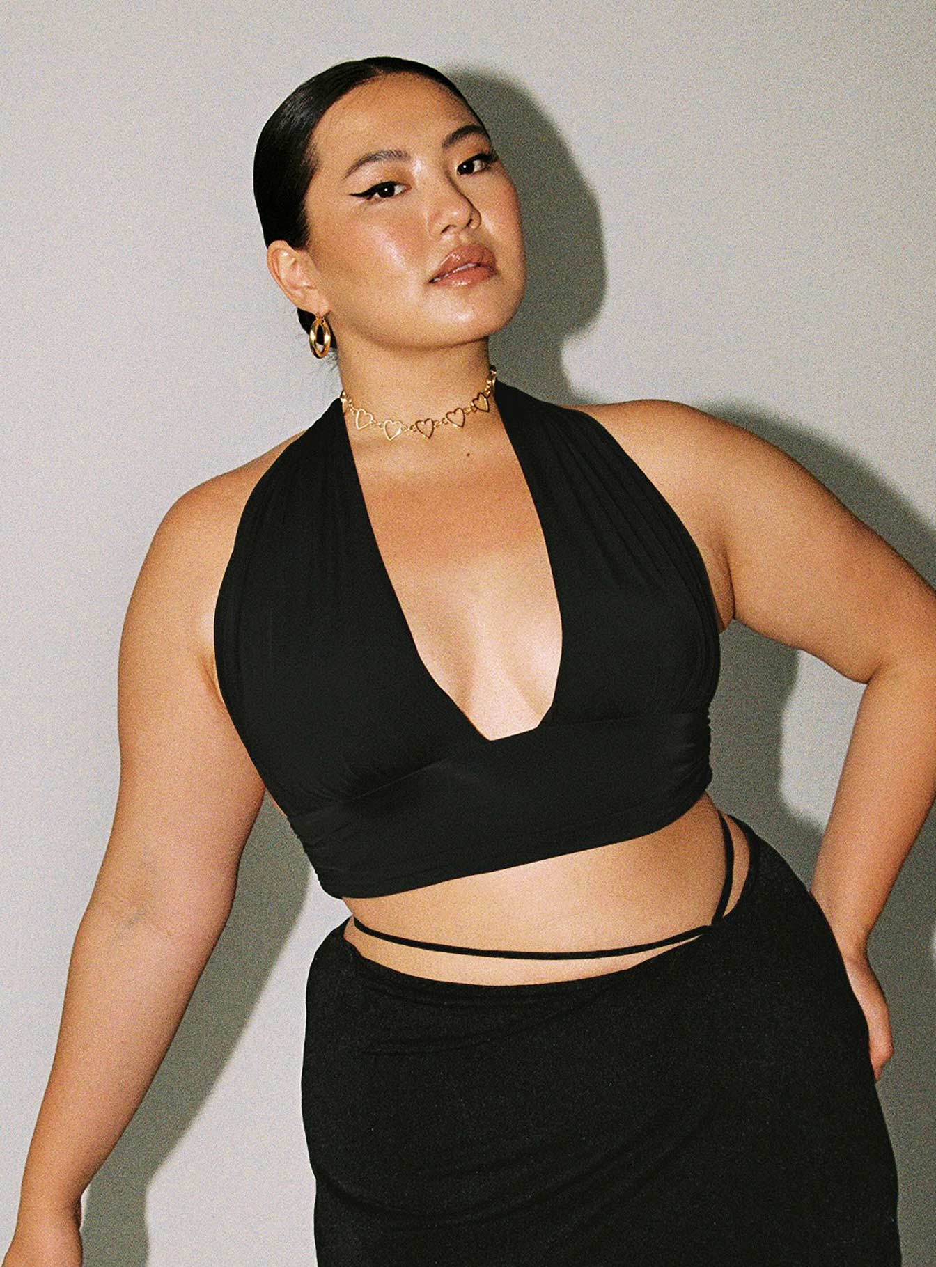 front view of model wearing Princess Polly Jordy Top Black Curve Eco Sleeveless Plunger 