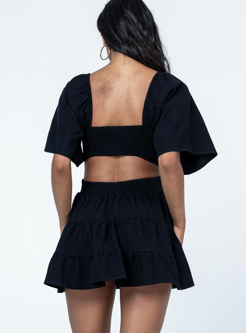 back view of model wearing Princess Polly Dark Star Mini Dress Black Square Neck 