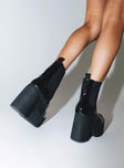 Black platform boots Faux patent leather Ankle boot style Square toe Elastic gusset detailing Pull tab at back