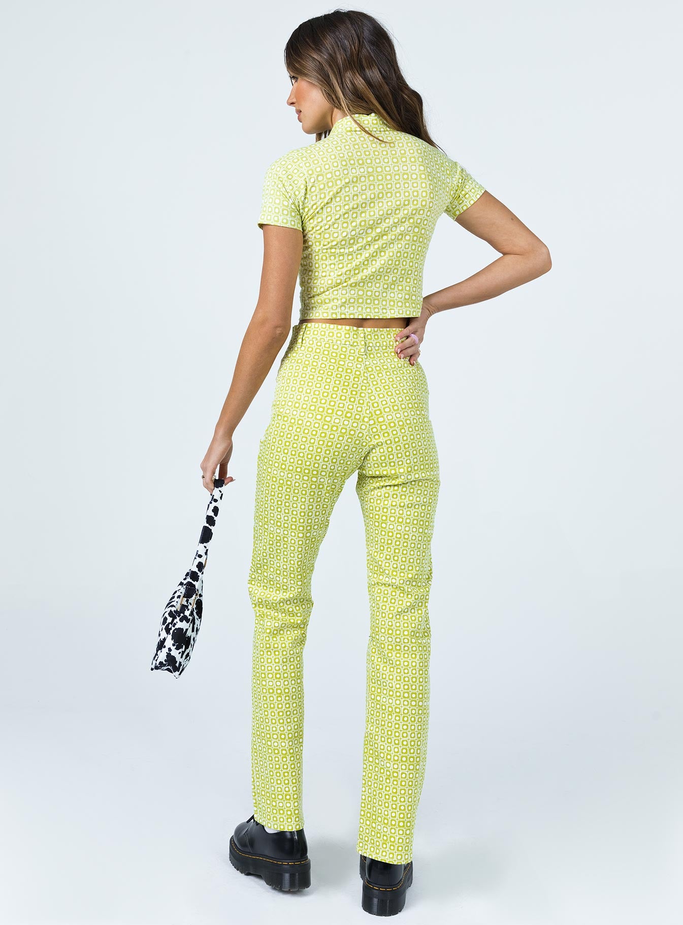 back view of model wearing Princess Polly Motel Zoven Trouser Green Geo Retro 