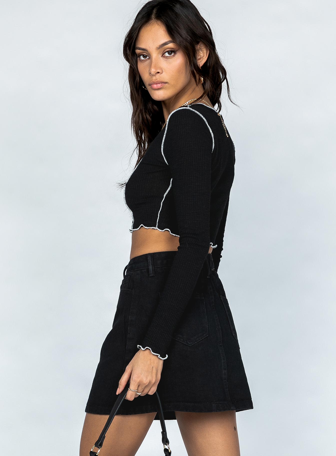   side view of model wearing Princess Polly Demi Denim Mini Skirt Black 