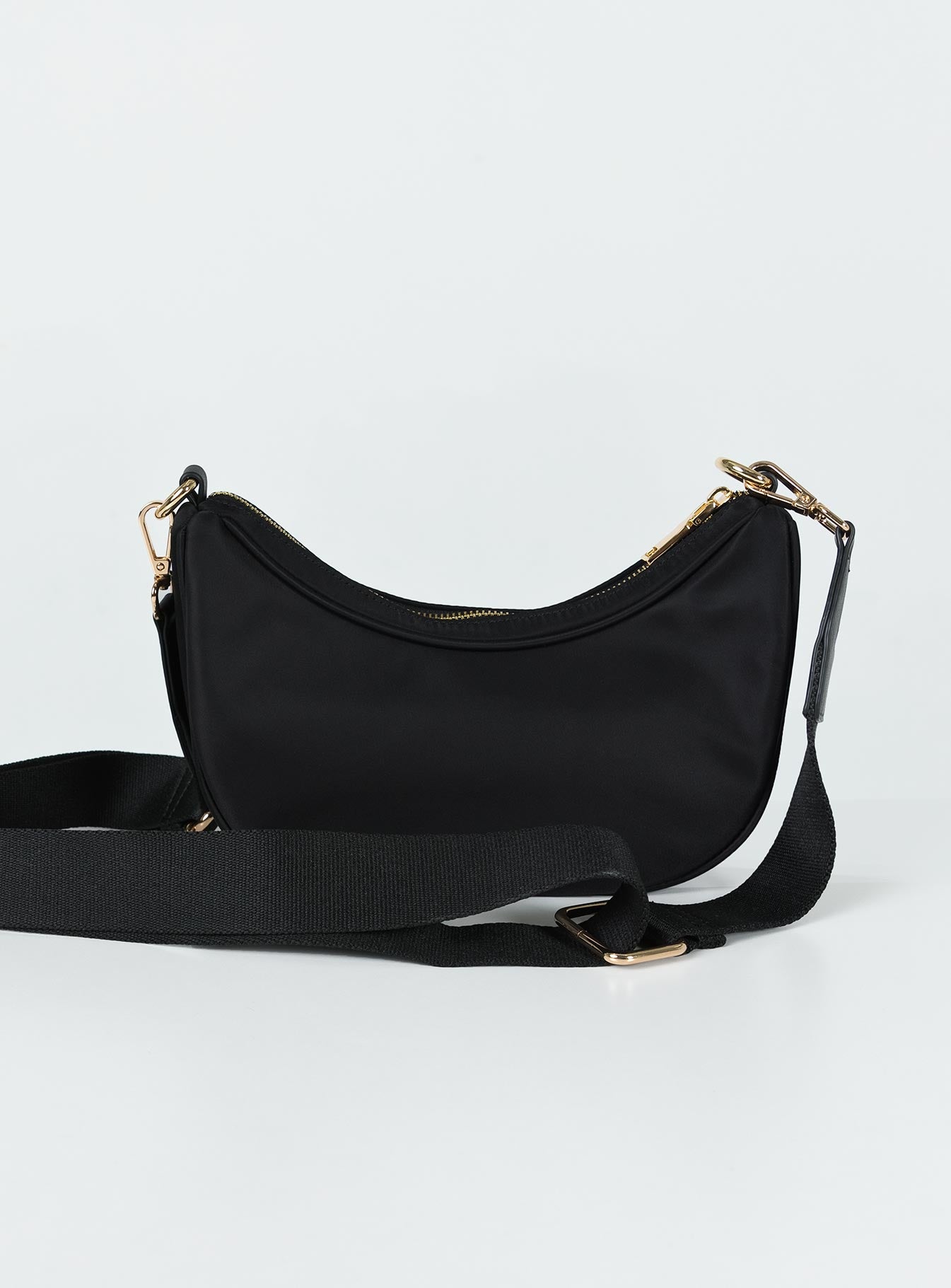 Crossbody bag Zip fastening Gold-toned hardware Two internal pockets Flat base