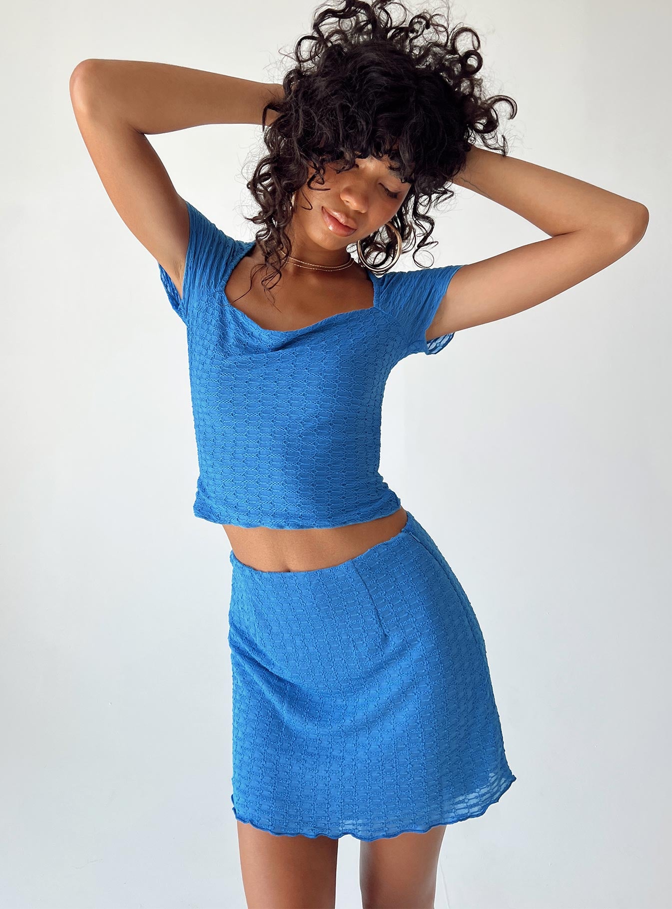Front view of model wearing  front Princess Polly Short Sleeves Asymmetric Neckline  Merrin Top Blue
