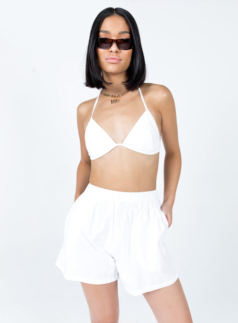 Matching three-piece set Bra top  Halter neck tie fastening  Oversized vest top  Lapel collar  Button front fastening  Twin front pockets  High waisted shorts  Elasticated waistband  Twin hip pockets 