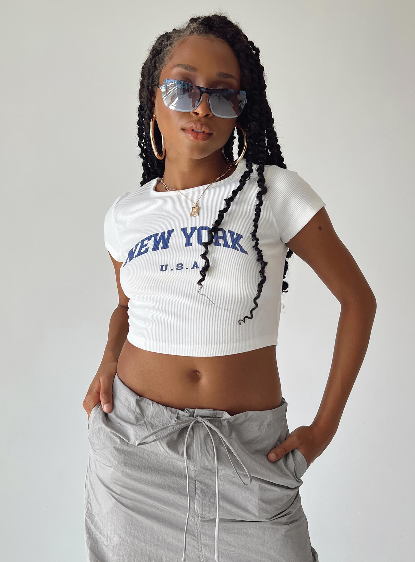 side view of model wearing Princess Polly New York Baby Tee White Short Sleeves Crew Neck 