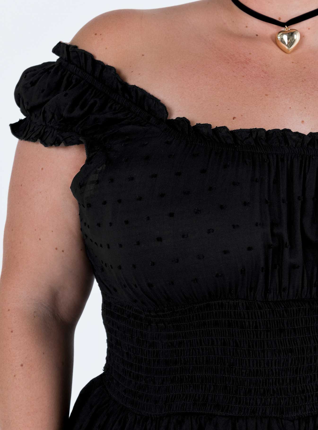 Black romper Can be worn on or off the shoulder Soft textured material Shirred waistband Ruffle detailing