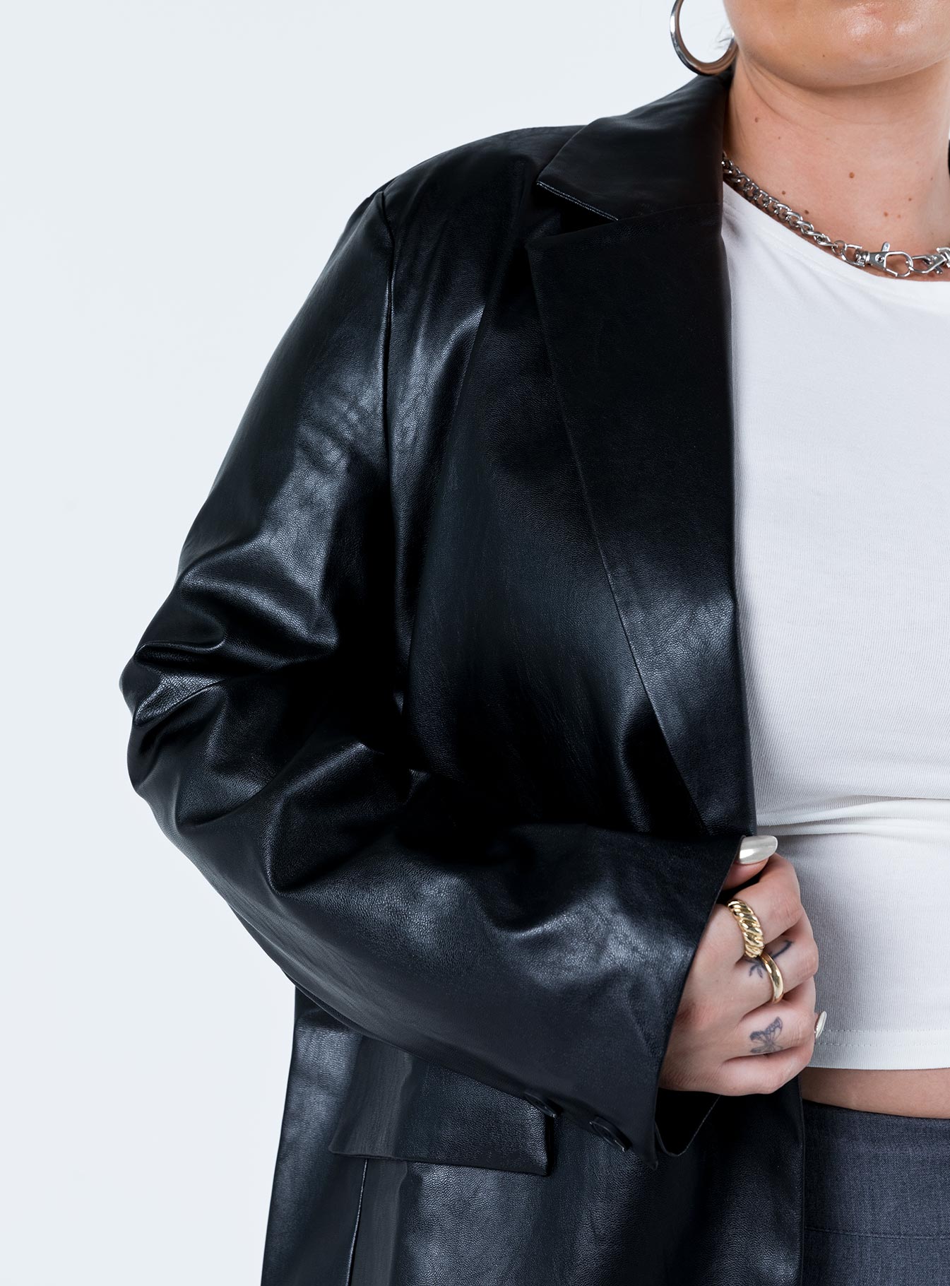 Black blazer Faux leather material Twin front pockets Padded shoulders Fully lined