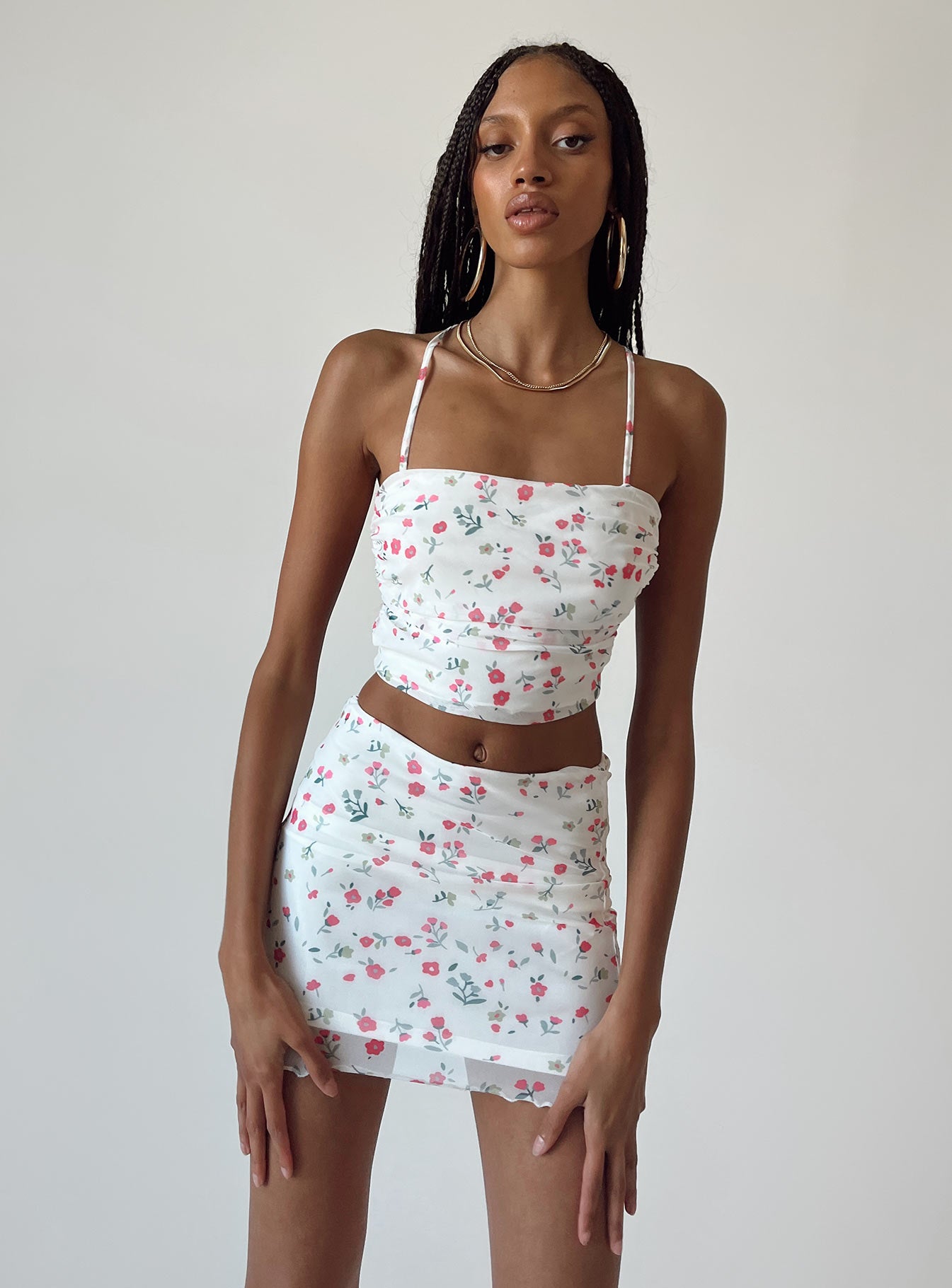 Matching set Mesh material  Floral print  Cowl neckline  Lace-up back tie fastening  High waisted mini skirt  Elasticated waist  Lettuce edge hem 