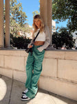 Front view of model wearing  front Princess Polly Low Rise Jeans  Miami Vice Pants Green