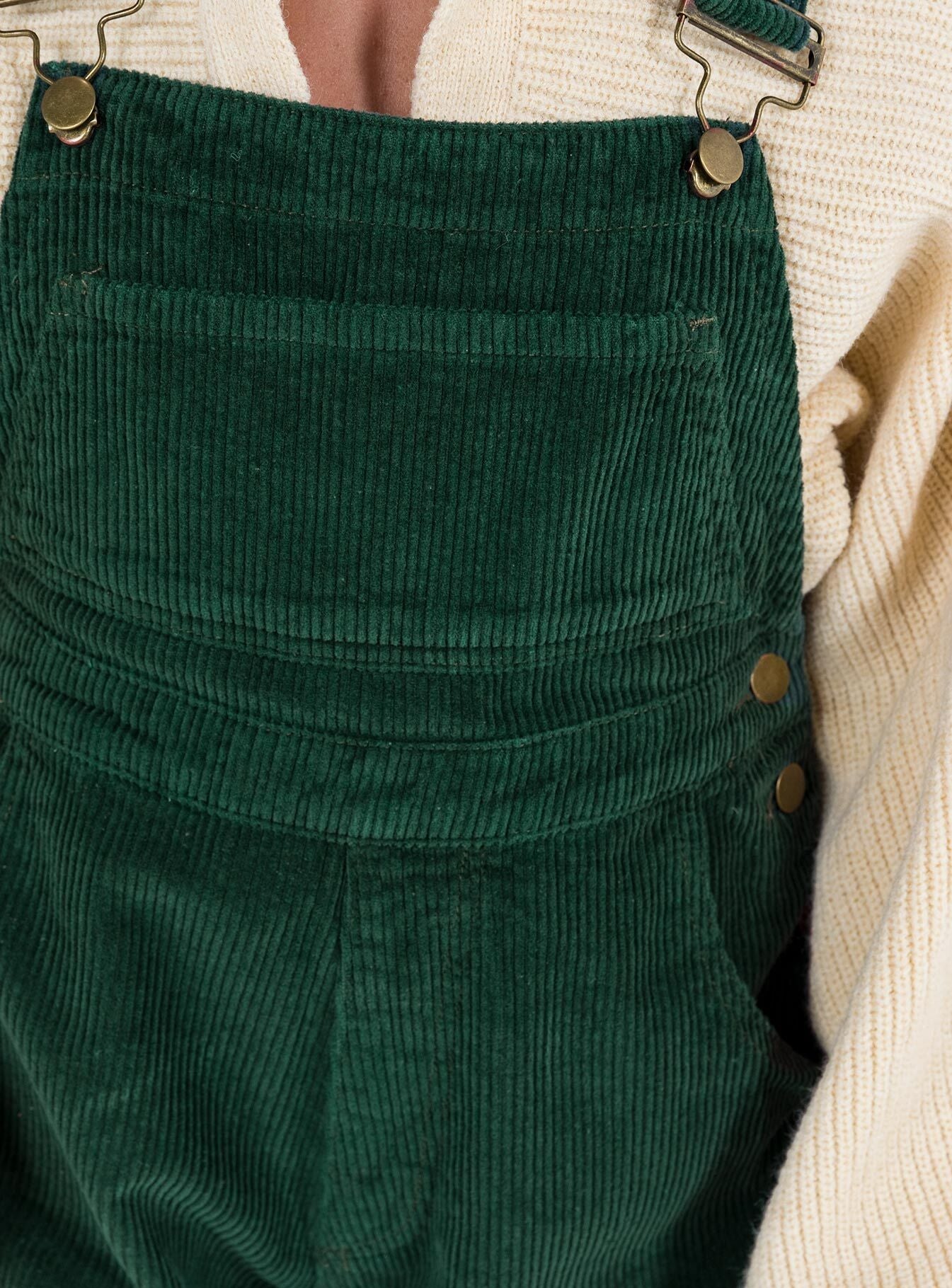 Khaki overalls Cord material  Adjustable shoulder straps  Button fastening at hips  Chest pocket 