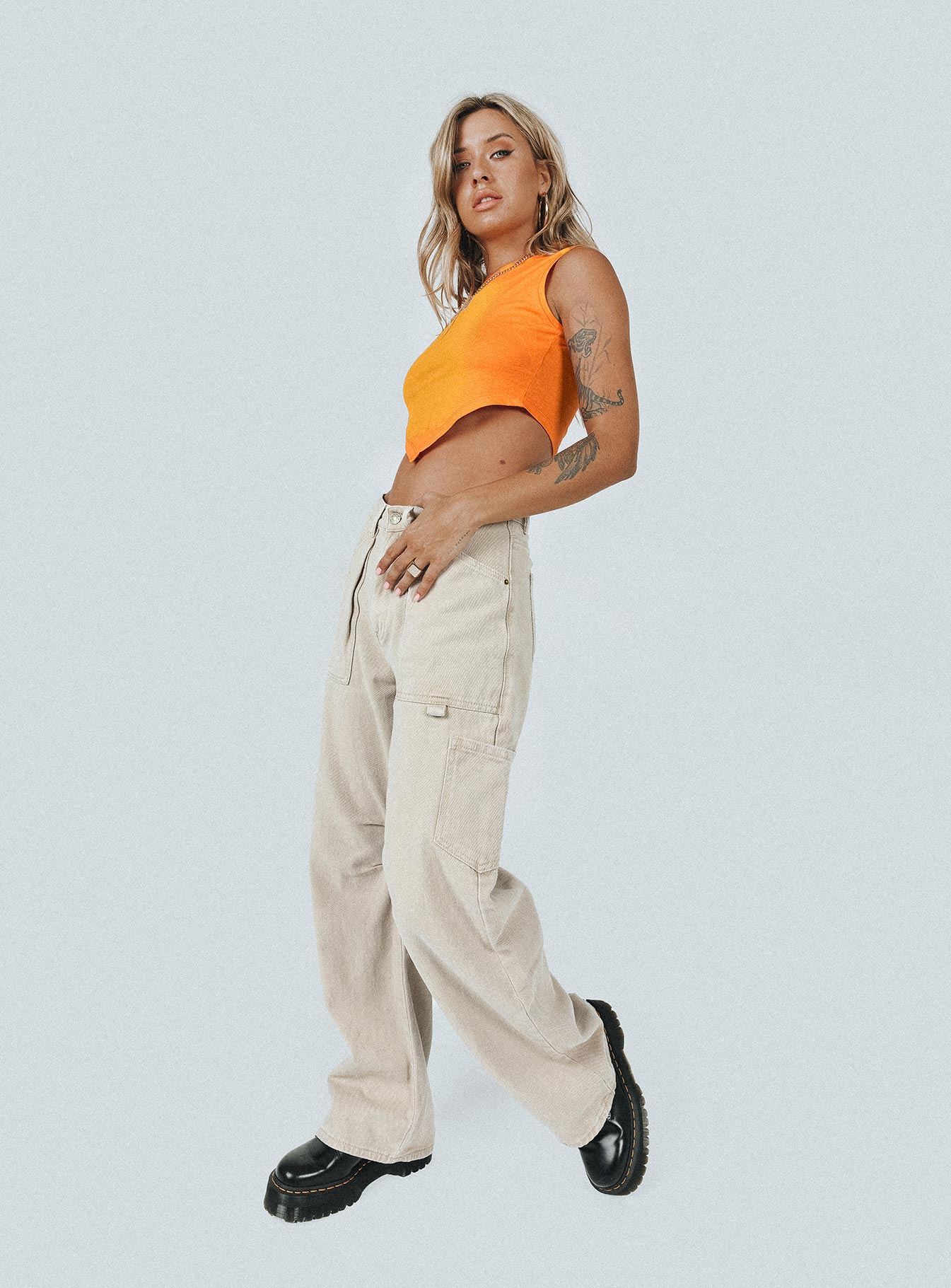 side view of model wearing Princess Polly The Ragged Priest Ignite Vest Orange / Yellow Sleeveless High Neck 