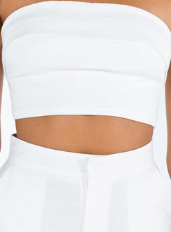 White matching set Linen look material Strapless crop top Folded neckline Inner silicone strip at bust Zip fastening at back High waisted pants Front button and zip fastening  Twin hip pockets