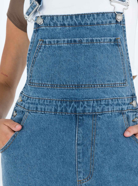 Overalls Mid wash denim Adjustable shoulder strap  Large chest pocket  Four classic pockets  Button fastening at hips  Wide leg