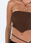 Front view of model wearing  front Princess Polly Sleeveless Asymmetric Neckline  Carnlea Strapless Top Brown