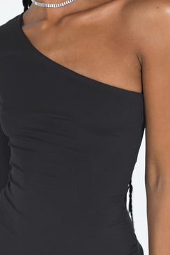 Front view of model wearing  front Princess Polly Asymmetric Neckline  Tomer One Shoulder Mini Dress Black