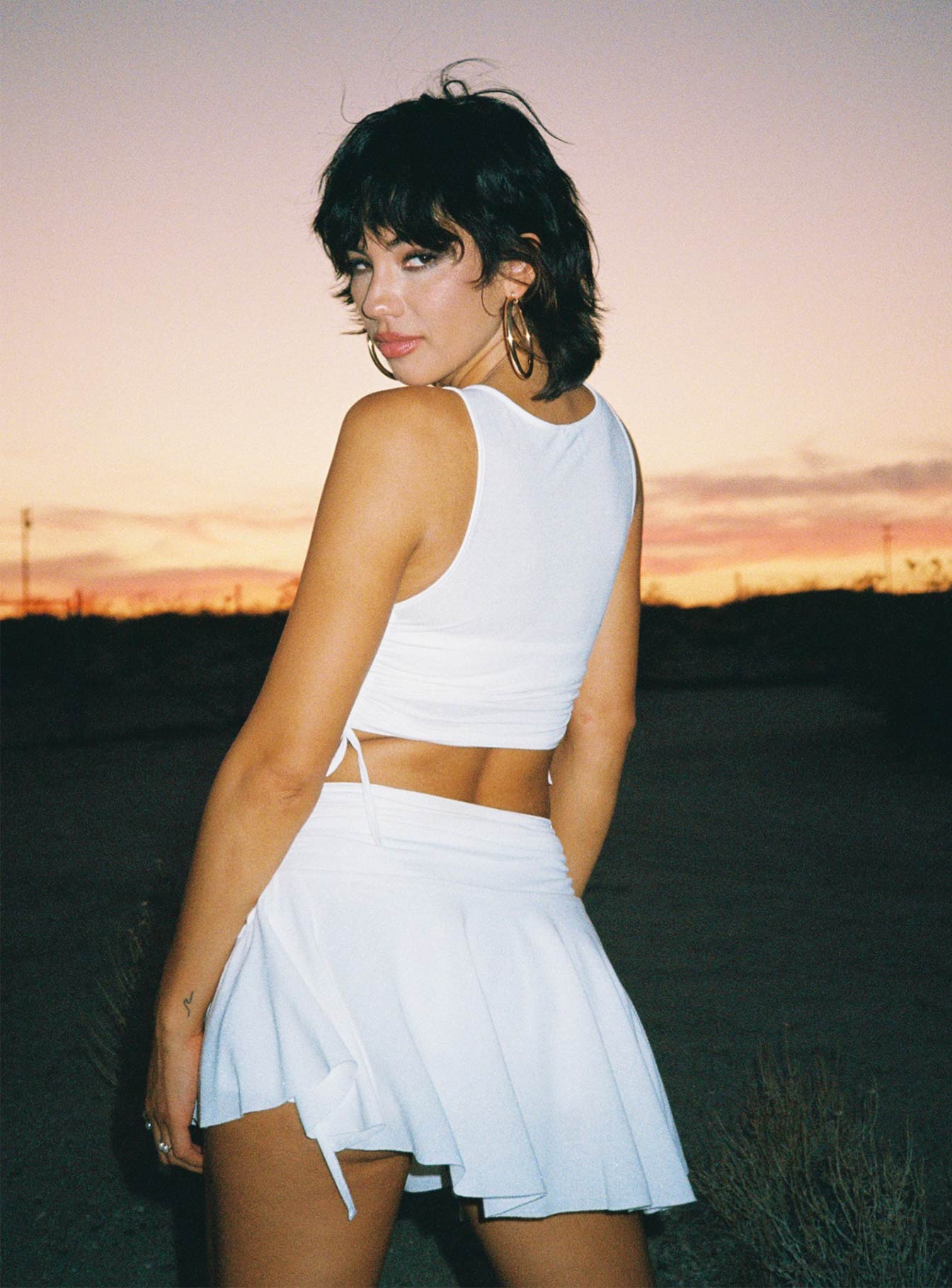 Matching 3 piece set Singlet top  Low scoop neckline  Strapless crop top  Adjustable tie fastening at bust  High waisted mini skirt  Adjustable tie ruching at sides of top & skirt  