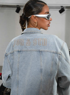 Denim jacket Light wash denim Classic collar Button fastening at front Four pocket design Gold-toned hardware Embroidered graphic at back