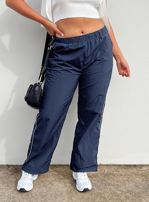 Front view of model wearing  front Princess Polly Low Rise Pants  Downtown Parachute Pants Navy