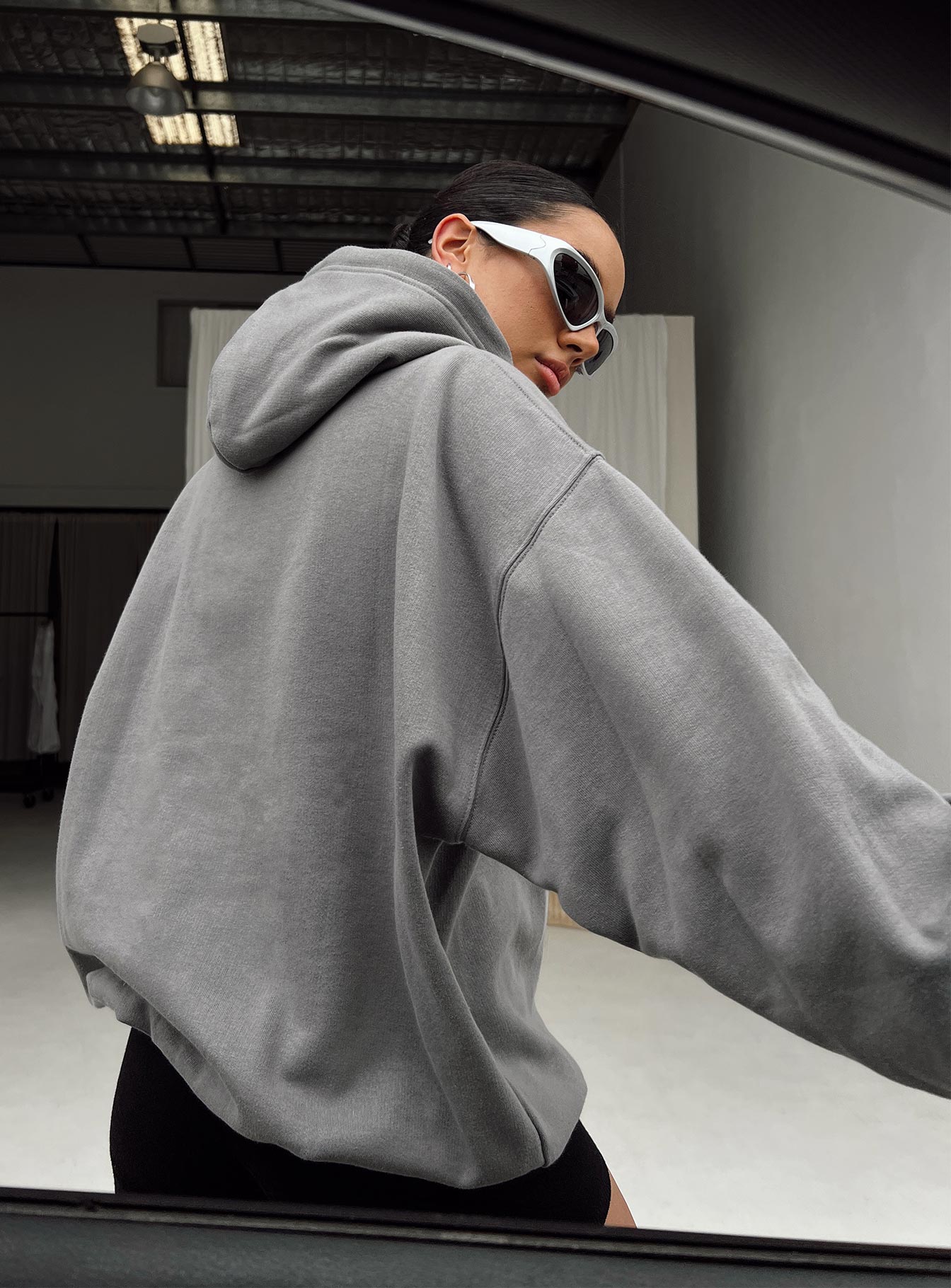 back view of model wearing Princess Polly Princess Polly Hooded Sweatshirt Bubble Text Charcoal / Light Pink Long 